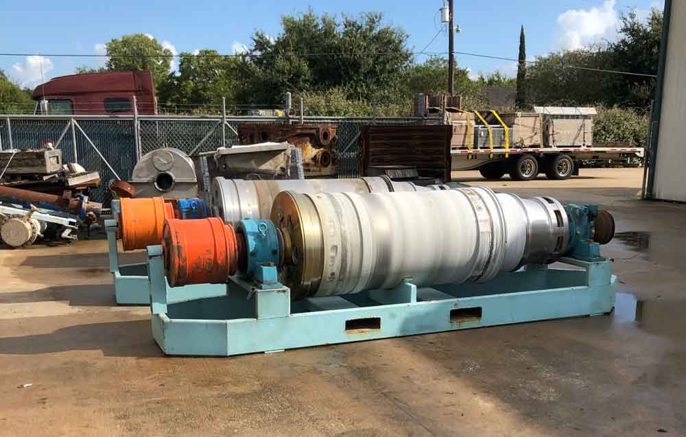 Worn decanter centrifuge before rebuild, staged in the yard