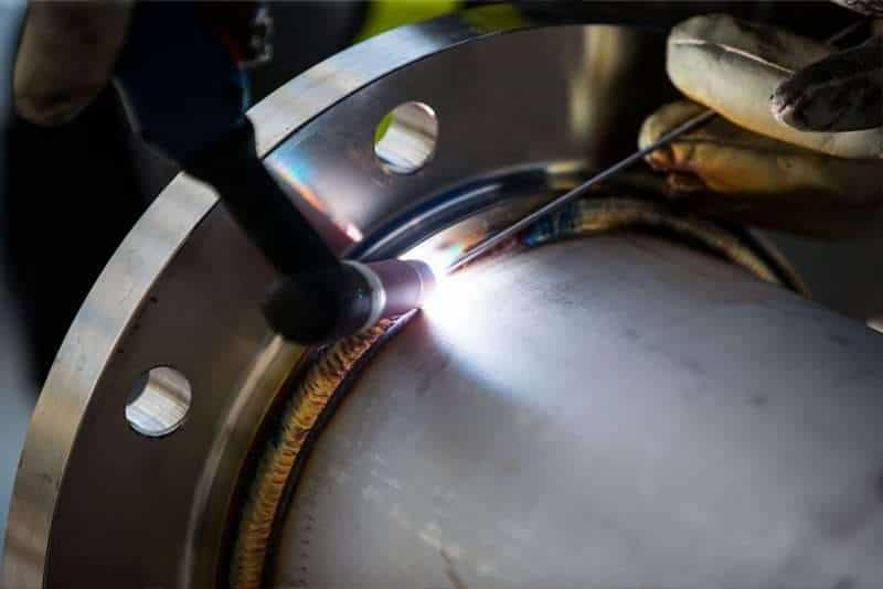 Welding and hard-surfacing a centrifuge for abrasive mining and manufacturing duty