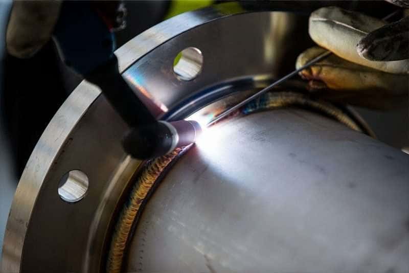 Hard-surfacing and welding a centrifuge component